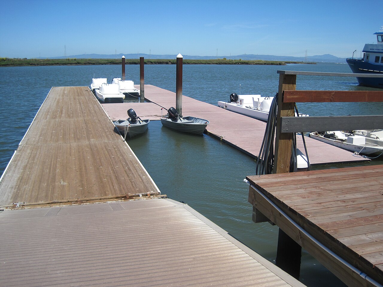 Arrillaga Family Rowing and Sailing Center — The pier of Stanford Rowing and Sailing Center along Redwood Creek in Redwood City, California.
